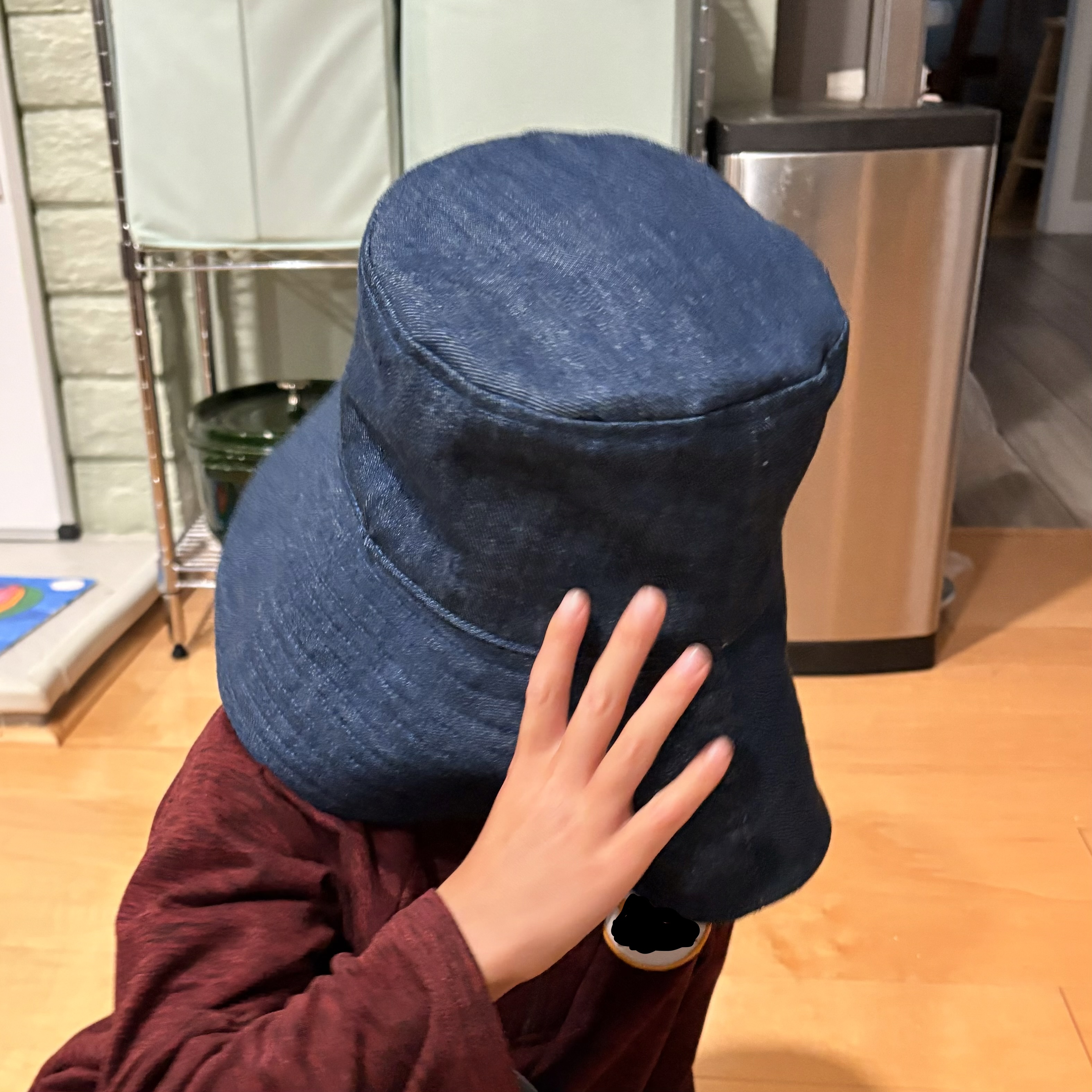 A wide brim bucket hat made from dark blue denim
